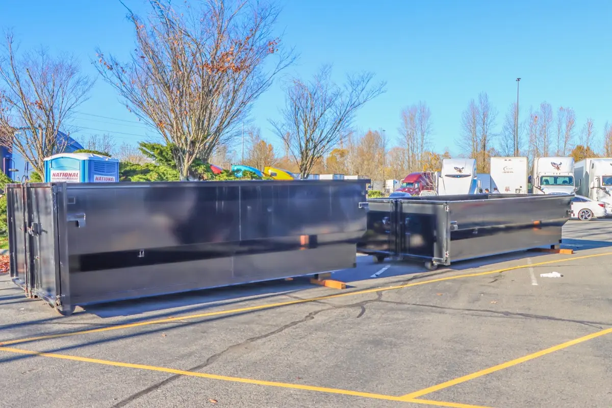 Professional dumpster rental service with roll-off container on residential driveway in Granite Shoals